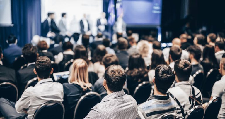 A large group of conference participants sitting in a hall.