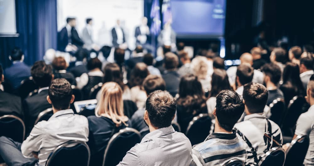 A large group of conference participants sitting in a hall.