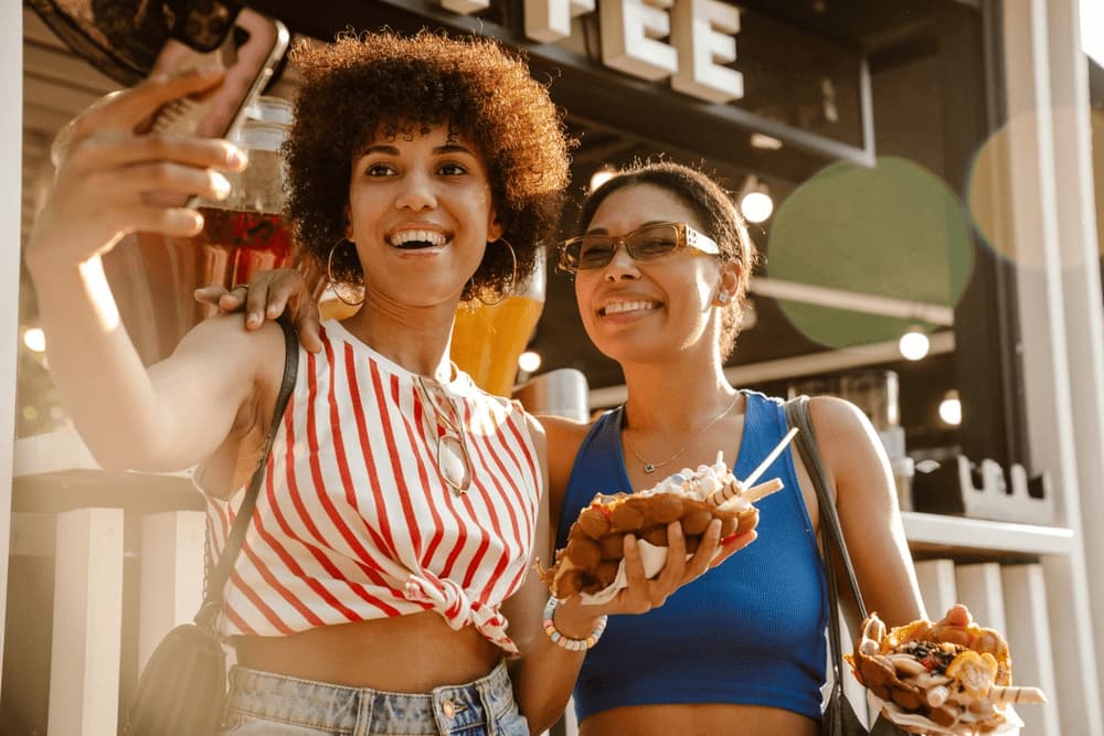 Travelers trying street food at a weekend market near IMPACT Arena Muang Thong Thani